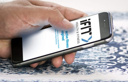 New York, USA, September 2021: hand holding a phone with the iFit mobile app on the screen. iFIT is a leading health and fitness platform