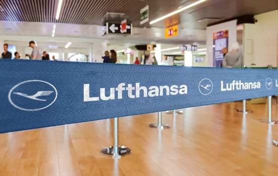 Berlin, GER, May 2022: blue belt barrier with white Lufthansa airlines logo. Lufthansa is Germany flag carrier. Travel and airport security