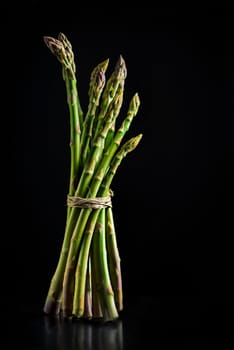 Fresh asparagus on black background