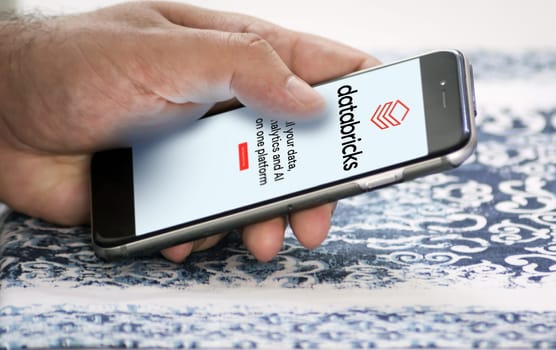 San Francisco, CA, US, May 2022: hand holding a phone with Databricks company web page on screen. Databricks is an enterprise software company