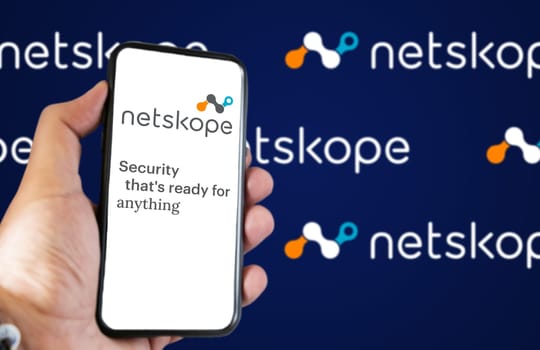 San Francisco, CA, US, May 2022: hand holding a phone with Netskope company web page on screen. In background the logo Netskope blurred and repeated. Netskope is a security software company
