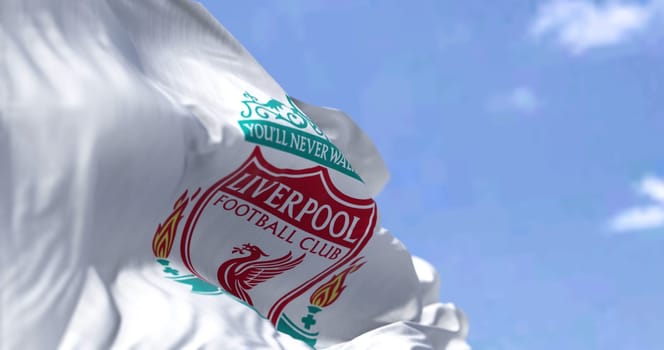 Liverpool, UK, May 2022: The flag of Liverpool Football Club waving in the wind on a clear day. Liverpool F.C. is a professional football club based in Liverpool, England