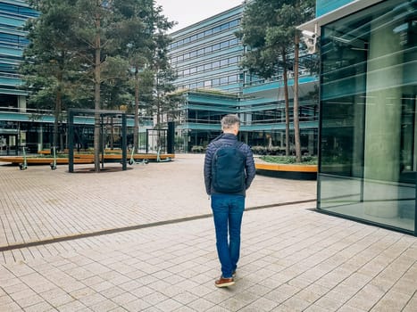 A man goes to work in a modern quarter.