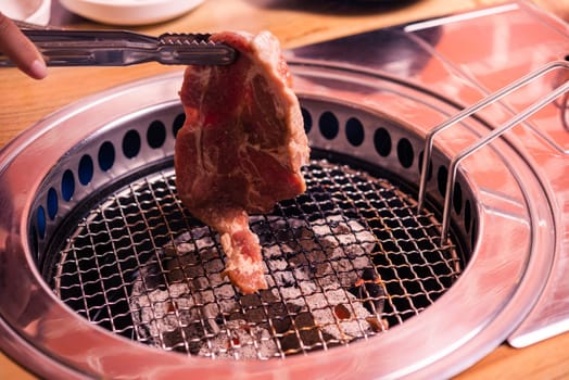Korean beef barbecue on hot coals. Grill meat pork Korean BBQ traditional style on stove serve in restaurant, Japanese food