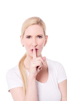 Beautiful woman keeping finger on her lips