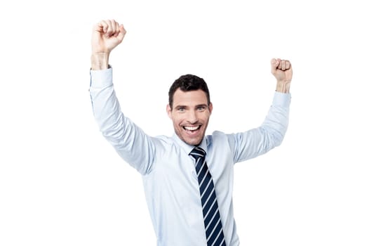 Successful businessman with raising hands