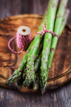 Fresh green asparagus on wooden table