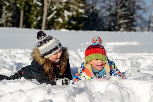 two children playing in the snow