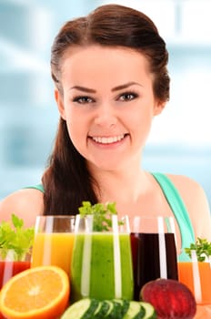 Young woman with variety of vegetable and fruit juices. Detox diet.