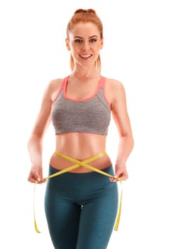 Young woman measuring herself. Weight loss.