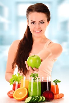 Young woman with variety of vegetable and fruit juices. Detox diet.