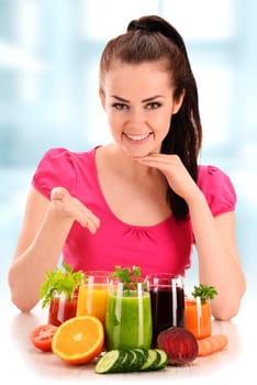 Young woman with variety of vegetable and fruit juices. Detox diet.