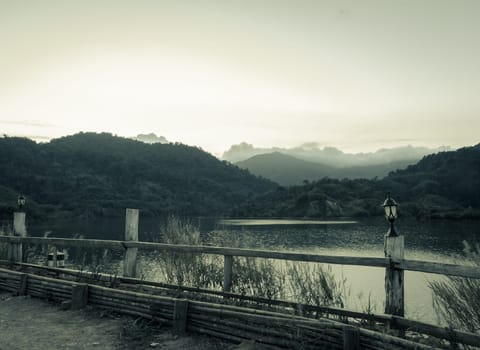 Reservoir with mountain view in vintage style color