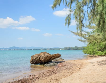 Tropical beach shore with rock in Thailand