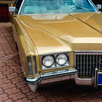 Old retro or vintage car or automobile front side with front lights or headlights and radiator grill
