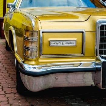 Old retro or vintage car or automobile front side with front light or headlight