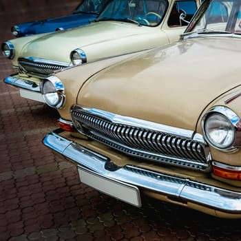 Old retro or vintage car or automobile front side with front lights or headlights and radiator grill