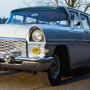Old retro or vintage car or automobile front side with front lights or headlights and radiator grill
