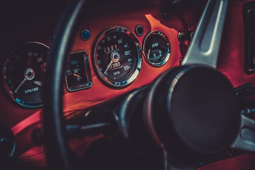 Dashboard and steering wheel in interior of retro automobile. Processed by vintage or retro effect filter