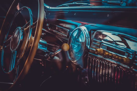 Interior of old retro automobile with steering wheel and dashboard. Processed by vintage or retro effect filter
