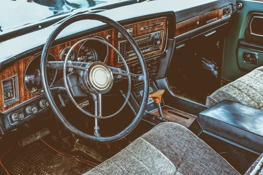 Interior of old retro vintage automobile or car with steering wheel and dashboard. Processed by vintage or retro effect filter