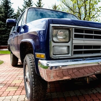 Old retro or vintage car or automobile front side with front lights or headlights and radiator grill
