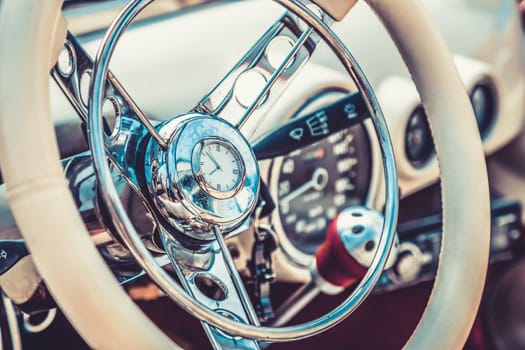 Steering wheel in interior of retro old or vintage automobile or car. Processed by vintage or retro effect filter