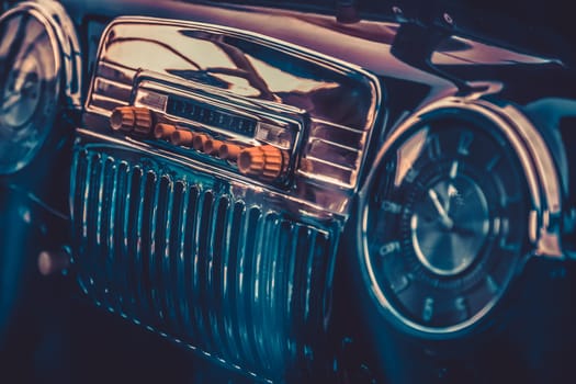 Radio in dashboard in interior of old vintage automobile. Processed by vintage or retro effect filter