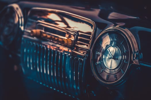 Clock on dashboard in retro interior of old automobile. Processed by vintage or retro effect filter
