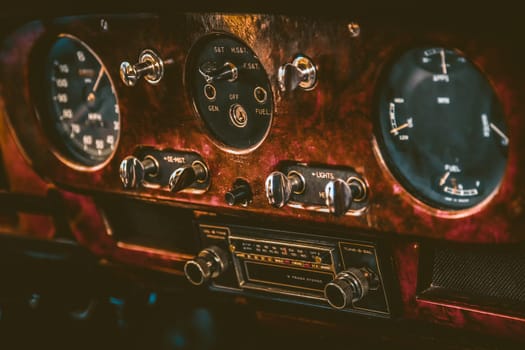 Radio in dashboard in interior of old vintage automobile. Processed by vintage or retro effect filter
