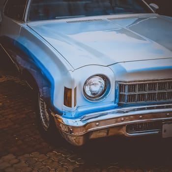 Old retro or vintage car or automobile front side with front light or headlight. Processed by vintage or retro effect filter