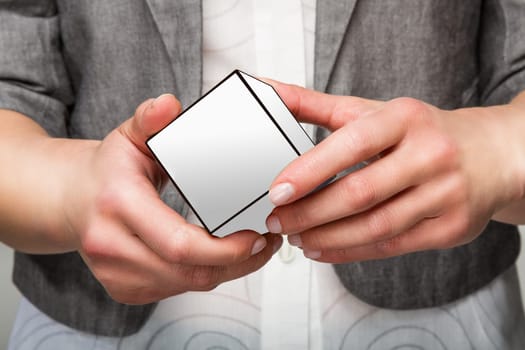Woman or female hands holding white cube
