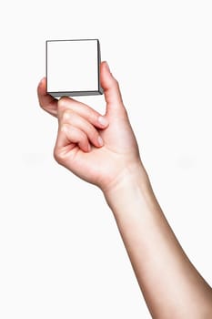 Hand holding white cube on white background