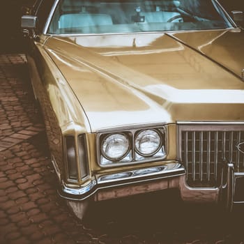 Old retro or vintage car or automobile front side with front lights or headlights and radiator grill. Processed by vintage or retro effect filter