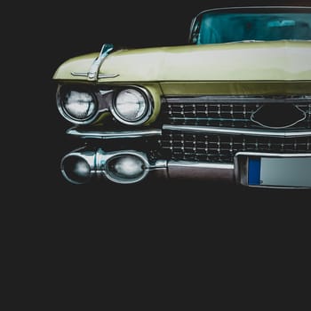 Old retro or vintage car or automobile front side with front lights or headlights and radiator grill. Processed by vintage or retro effect filter