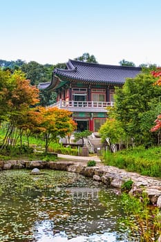 Traditional korean architecture old building or monks temple with little pond in South Korea at autumn