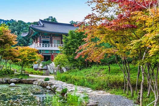 Traditional korean architecture old building or monks temple with little pond in South Korea at autumn