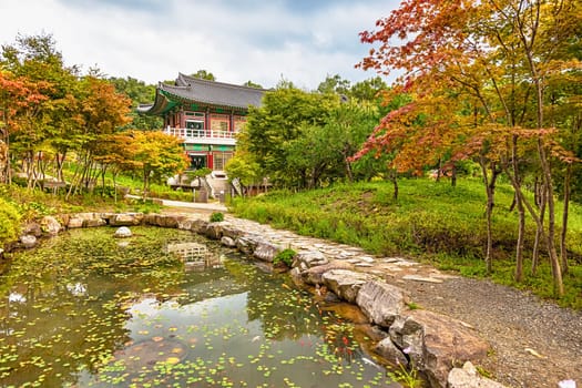 Traditional korean architecture old building or monks temple with little pond in South Korea at autumn