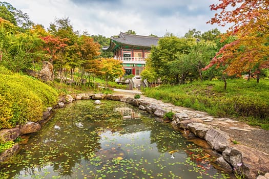 Traditional korean architecture old building or monks temple with little pond in South Korea at autumn