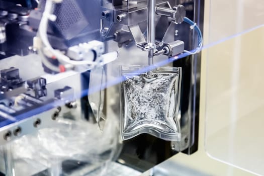 Machine filling liquid substance in transparent package on pharmaceutical industry manufacture or chemical plant