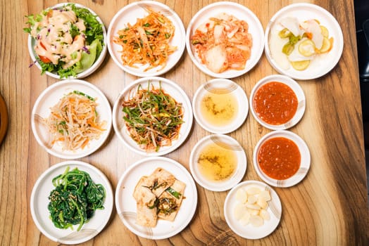 Spicy Kimchi group. Korean pickle or Pickled radish vegetables and seasoning on bowl on wood table background, Japanese food