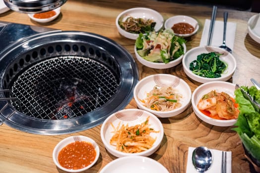 Spicy Kimchi group. Korean pickle or Pickled radish vegetables set and seasoning on bowl on stove serve wood table background, Japanese food