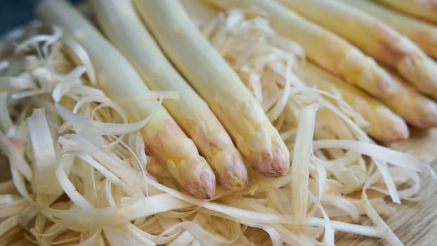 Fresh peeled white asparagus directly from the field on a kitchen table