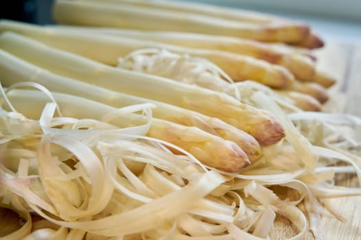 Fresh peeled white asparagus directly from the field on a kitchen table