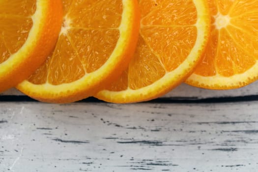 Large slices of orange on a wooden table..