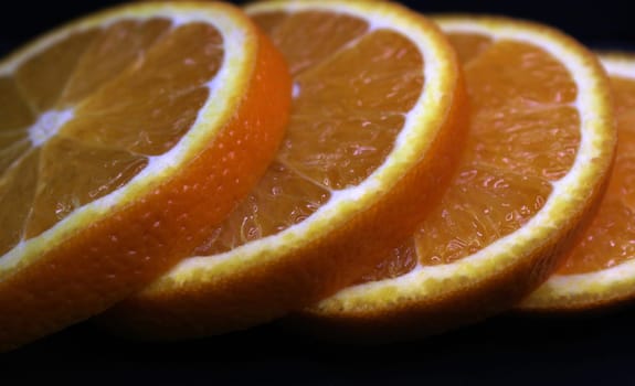 Close-up of orange slices on a black background..