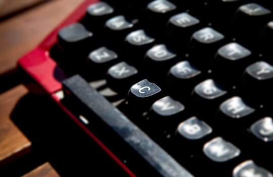 1970s dusty typewriter. Selective focus on key C