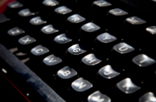 1970s dusty typewriter. Selective focus on key G