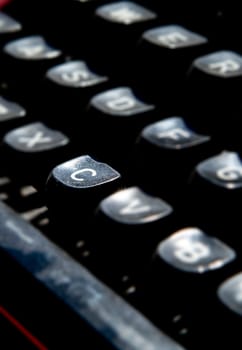 1970s dusty typewriter. Selective focus on key C