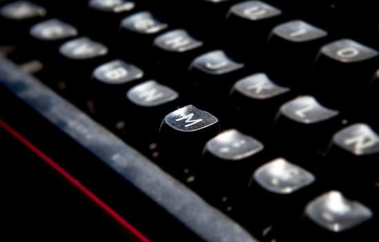 1970s dusty typewriter. Selective focus on key M